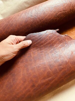 Full-grain bison leather with its natural grain and rugged texture